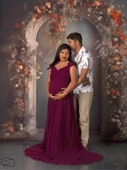 The protective and loving embrace of a partner. This portrait beautifully showcases the couple's bond as they await their new arrival.