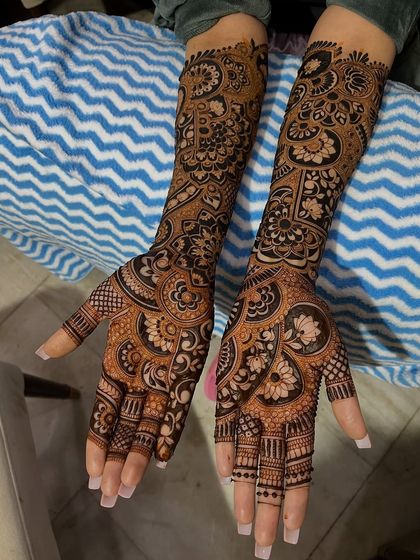 A gorgeous full-sleeve design with a mix of floral, paisley, and geometric patterns, perfect for the traditional bride.