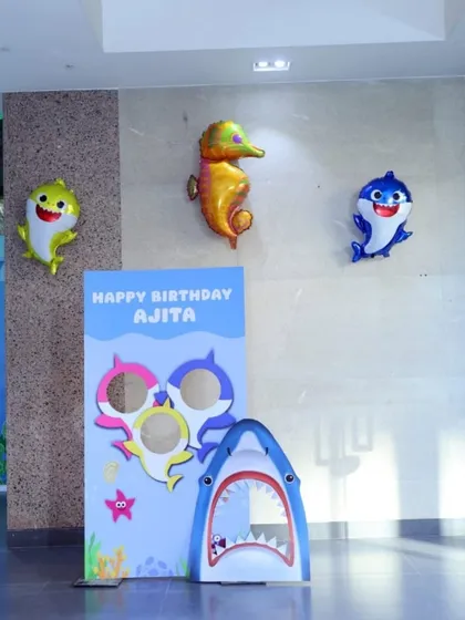 The complete Baby Shark photo booth area. It includes multiple cutouts and themed foil balloons to create a dedicated, fun-filled corner for guests to take pictures.