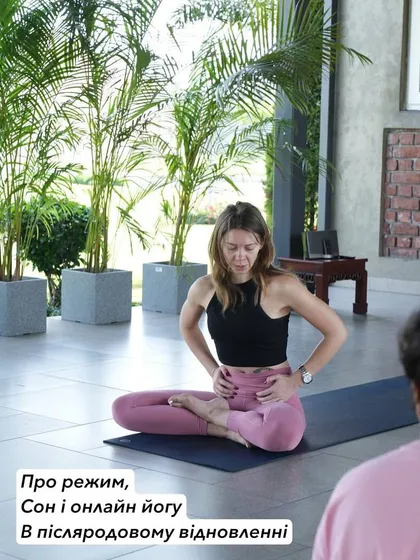 This photo captures a moment of teaching about postpartum recovery. I am explaining the importance of listening to your body, finding a new routine, and using online yoga as a tool for support during this transformative time.