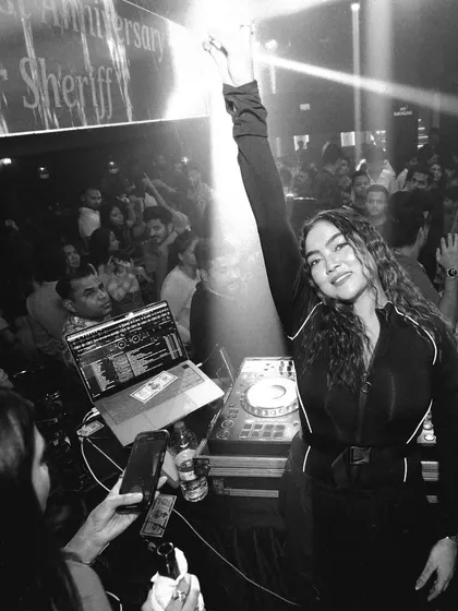 A classic moment of connection. This black and white shot captures the pure joy and energy shared between me and the crowd, with my hand in the air, feeling the vibe.