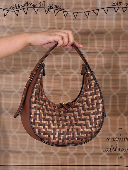 The Aishwarya crescent bag in our Madurai weave. The combination of Honey Almond, Oak, and Bronze leathers in a hand-woven pattern gives this chic and elegant shoulder bag a unique and eye-catching texture.
