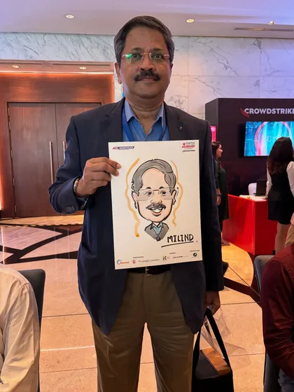 Live caricatures are a fantastic way to engage attendees at corporate events. Here's a guest from a conference at Jio World Convention with his unique, hand-drawn souvenir.