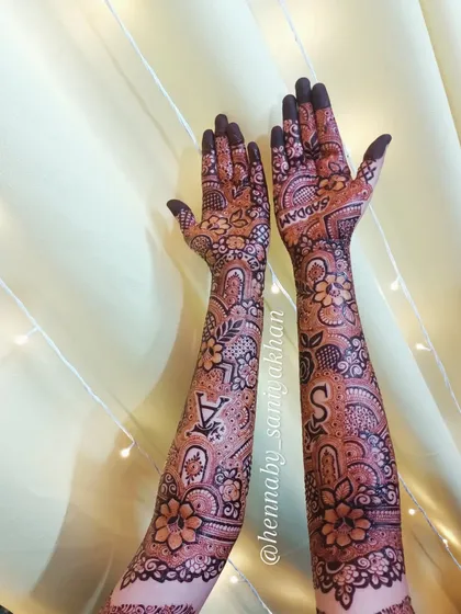 A full view of the personalized design, showing the initials on the forearms.