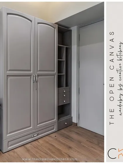 A full view of "The Open Canvas" wardrobe. The classic routed shutters in a neutral hue are contrasted with the warm wood grain of the open shelving, creating a balanced and functional design.