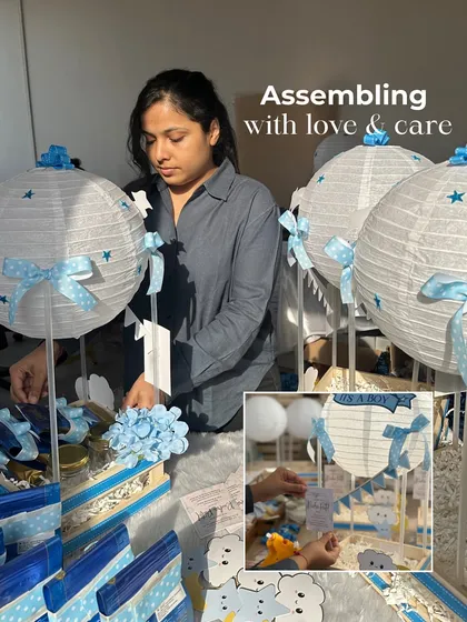 Assembling with love and care. Here I am putting together the 'It's a Boy' announcement hampers, making sure every element of the celestial theme is just right.