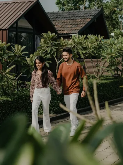 A simple, happy shot of the couple walking hand-in-hand through a beautiful resort garden. This image captures the easy, comfortable feeling of being with the one you love.