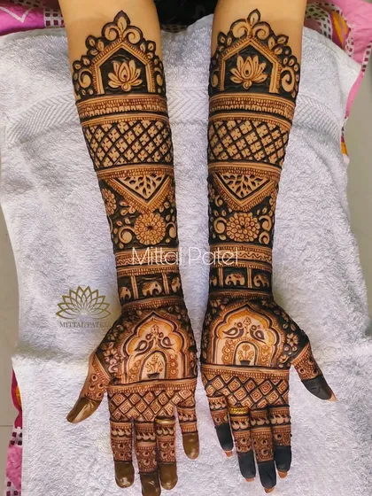 This is a beautiful example of a non-figure bridal mehndi. It is filled with classic motifs like elephants, peacocks, and lotuses, all arranged in a symmetrical and aesthetically pleasing pattern.