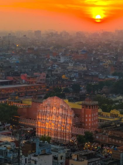 A closer look at the Hawa Mahal during that magical Jaipur sunset. This is a tighter composition from the same flight, focusing on the sun's direct glow on the palace's famous facade.