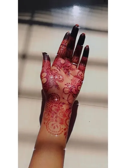 This photo captures the bright, vibrant red stage of the henna stain, which will continue to darken over the next 48 hours.
