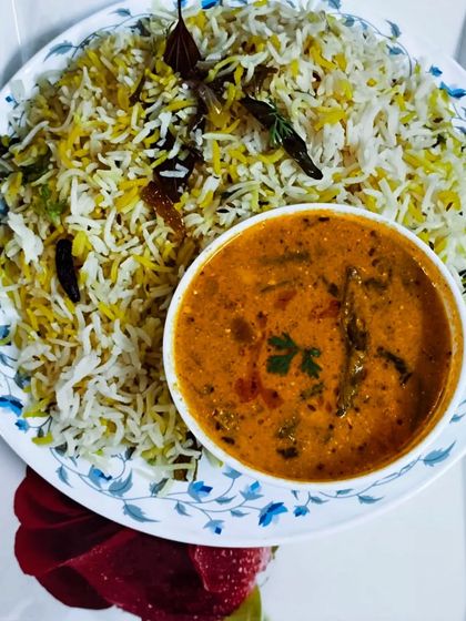 A simple and elegant meal of Bagara Rice served with a mixed vegetable kurma. The fragrant rice is made with whole spices and basmati rice, a Hyderabadi specialty.