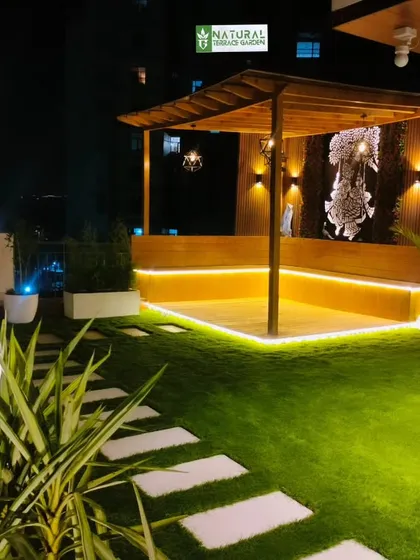 The Gwal Pahari pergola at night, with integrated bench seating and warm LED strip lighting creating a beautiful glow.
