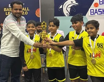 One of our coaches presenting the championship trophy to the winning U-12 team at the Bharat Basketball League.