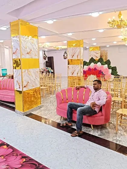 A view of our hall showing the comfortable VIP sofas we provide for special guests. The modern decor with marble-finish pillars and bright lighting creates a luxurious feel.