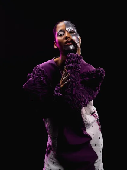 A portrait emphasizing the half-painted face and silver-tipped fingers, completing the futuristic concept.