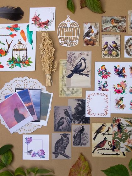 The "Birds of a Feather" journaling kit, filled with beautiful bird illustrations, feathers, and nature-themed ephemera.