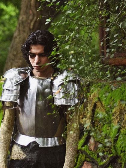 A surreal and beautiful portrait of a man in armor, walking through a lush green park. It feels like a character stepping out of a dream.