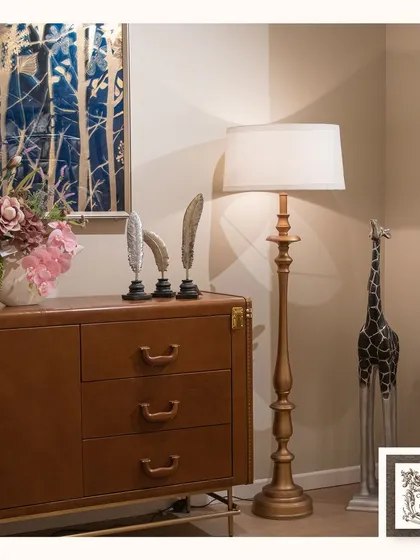 My classic floor lamp, finished in a soft gold, stands as an elegant statement piece. Its traditional silhouette and simple drum shade make it a versatile addition, providing beautiful ambient light for a reading corner or living room.
