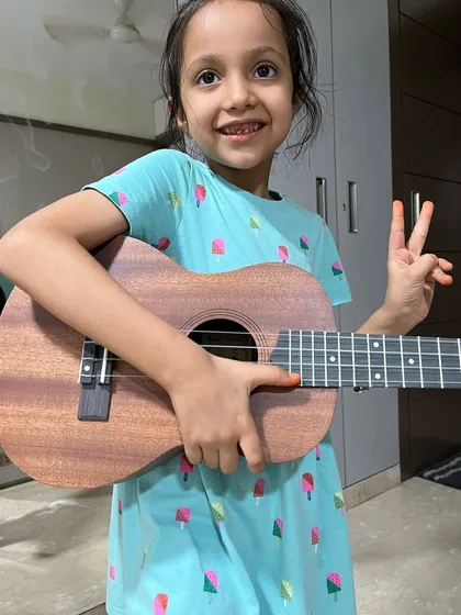 A young student is all smiles with her new ukulele. We love seeing the joy that a new instrument brings.