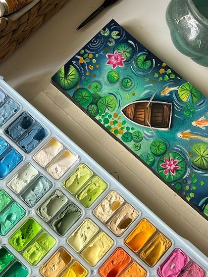 The finished koi pond painting next to my gouache palette, showing the beautiful range of greens and blues I used.