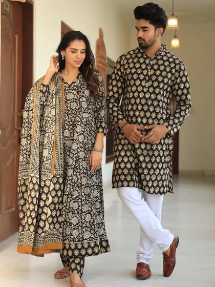 This black and beige couple's set showcases a beautiful floral jaal print. The woman's Anarkali has an impressive 18 kali (panels) for a full, flowing silhouette.