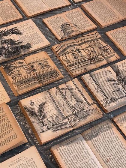 A collection of vintage books, each with a different architectural sketch of a Goan villa painted on its pages. This shows the completed series of unique, layered artworks.