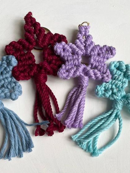 A collection of star keychains in shades of blue, burgundy, and purple. These are all made with earth-friendly cotton cord.