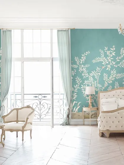 A bedroom should be a sanctuary of serene elegance. In this space, we used a delicate botanical wallpaper to create a whisper of poetry, complemented by classic furniture and light, airy textiles for a timeless and restful atmosphere.