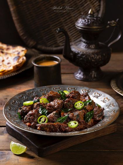 A closer shot of the Mutton Fry, highlighting the texture of the meat and the fresh green chillies.