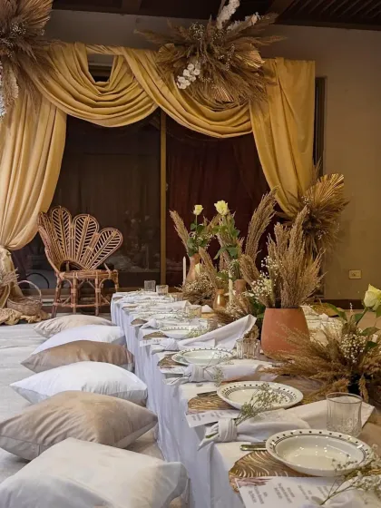 This intimate dinner was designed with an "Arabic Night" theme, featuring low floor seating on plush cushions and a warm, earthy color palette. The goal was to create a cozy and luxurious atmosphere for a pre-wedding celebration.