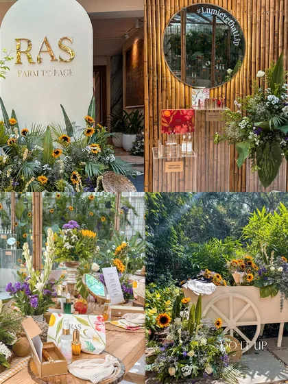 More views from the RAS beauty event, showcasing the product display bar, a branded cart, and seating areas all styled with fresh florals and natural textures for a cohesive brand story.