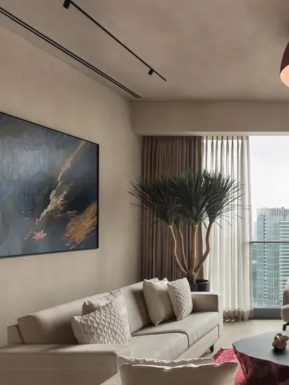 In the East Coast Residence, we used a palette of soft, earthy tones and rich textures to create a warm and inviting atmosphere. A large abstract painting adds a splash of color and personality to the minimalist living room design.