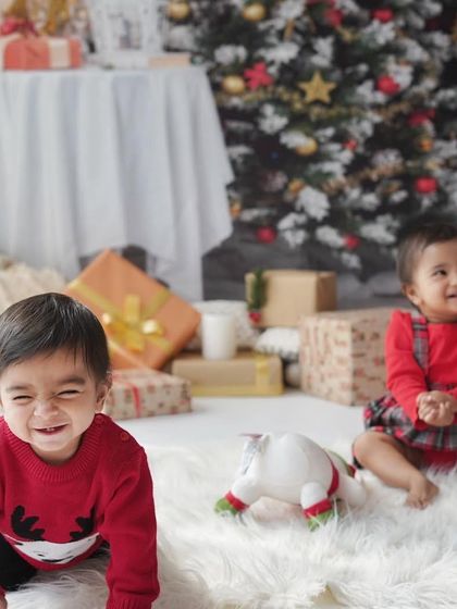 Twin toddlers enjoying the Christmas setup. Capturing the energy of two little ones during the holidays is a fun and rewarding challenge.
