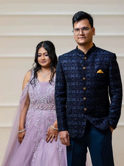 A formal portrait of the couple from their engagement, showcasing their coordinated outfits.