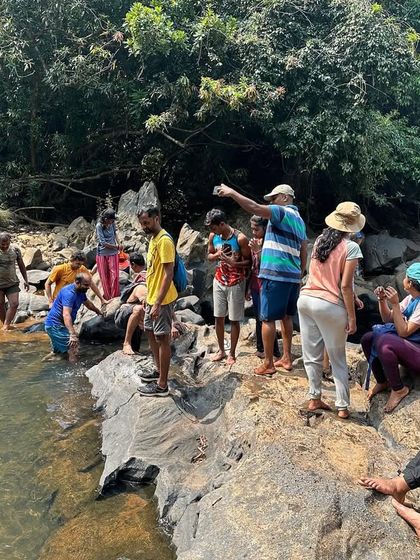 The group taking a break by the river, with the guide explaining the plan for the day.