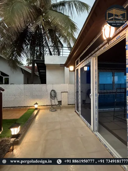 This side view at night highlights the seamless integration of the UPVC sliding doors and the ambient lighting scheme, which includes both wall-mounted fixtures and garden lights for a complete outdoor experience.