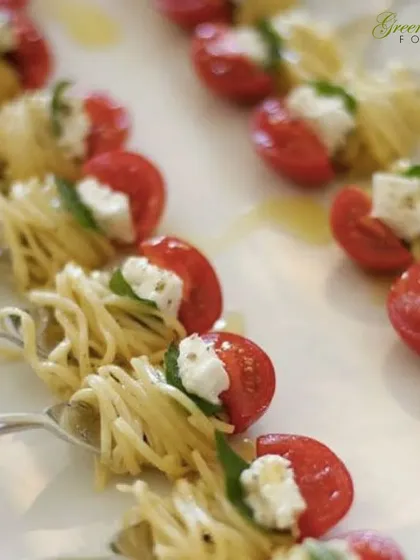 A bite of Italy. These elegant spaghetti nests are served on forks with a cherry tomato and fresh mozzarella, a perfect example of our creative, single-bite appetizers that are easy for guests to enjoy.