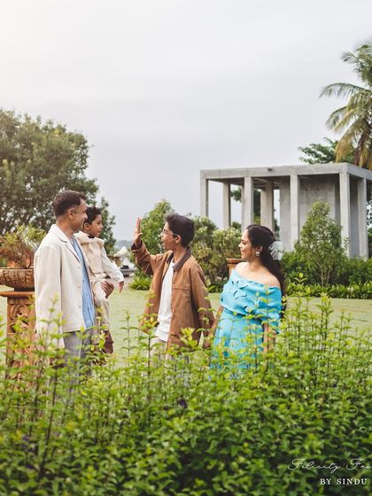 A candid shot of a family interacting in a lush green park. This photo shows the natural, unposed moments I strive to capture, telling the story of their connection.