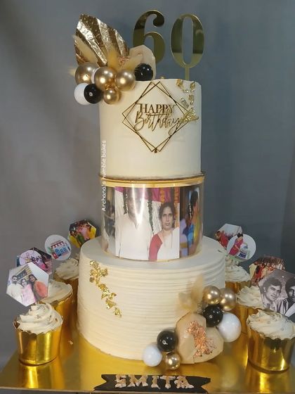 A three-tiered spacer cake for a 60th birthday, with the middle tier showcasing a collage of old photographs.