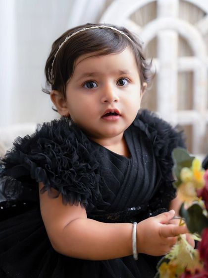 A little princess in black. Her soulful eyes and beautiful dress make for a stunning and unique portrait.