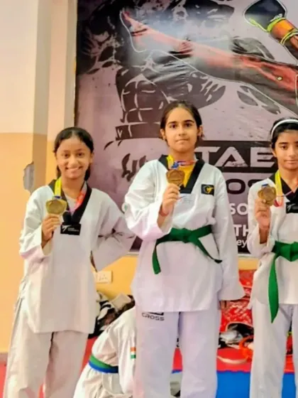 Three of our green-belt students showing off their gold medals after a competition. Their progress demonstrates the effectiveness of our belt progression system.
