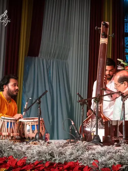 A gallery of cherished moments accompanying the legendary vocalist, Guruji Padma Bhushan Pandit Ajoy Chakraborty ji, at various prestigious festivals.