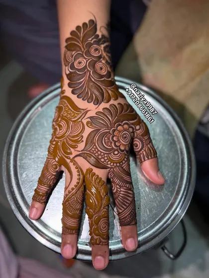 The full design, showing how all the elements come together to create a cohesive and beautiful pattern on the hand.