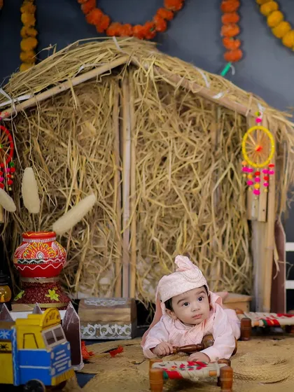 Another angle of the Lohri shoot, capturing the baby's inquisitive expression as he looks around the festive scene.