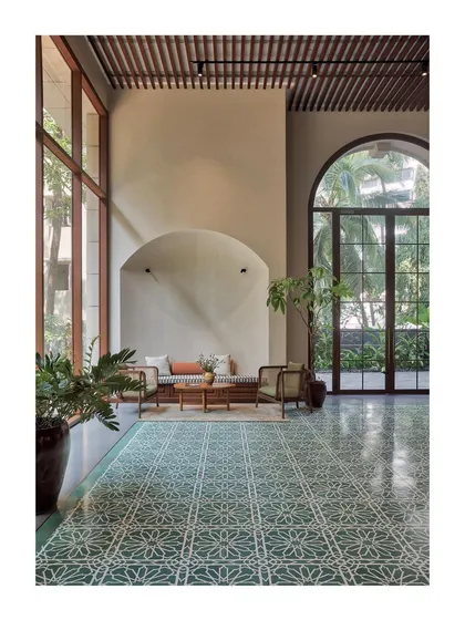 The lobby of the Artveda building was designed to create a feeling of tranquility and spirituality from the moment you enter. The grand arched windows, patterned cement tiles, and minimalist seating create a serene, artsy vibe without the obvious use of art.
