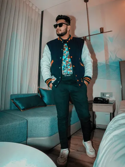 A full-body shot showcasing the varsity jacket and graphic tee. This is my go-to look for a comfortable yet stylish vibe.