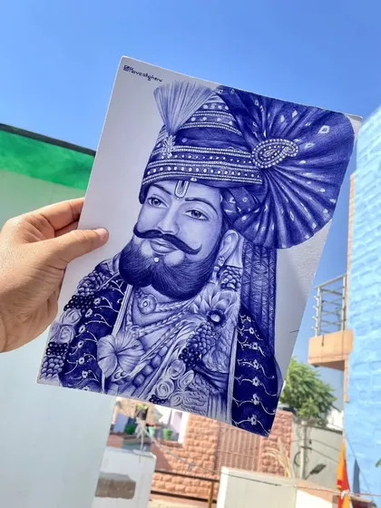 This portrait of Baba Ramdev Ji is drawn with a blue ballpoint pen. I focused on the intricate details of his turban and traditional Rajasthani attire, holding the finished art up against the blue sky of Jodhpur.