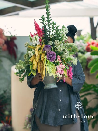 A beautiful, lush floral arrangement being prepared for the 'Garden of Gaia' event.