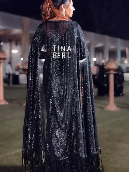 I believe in making a statement. This custom cape with my name on it is all about bringing that 'main character energy' to your event. I always dress to match the vibe, whether it's a glamorous cocktail night or a formal awards ceremony.