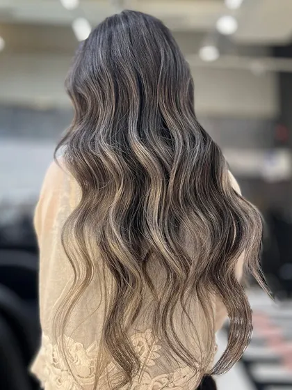 Catching the light with a beautiful ash balayage. The cool tones and soft waves come together to create a look that is both glamorous and effortlessly chic.